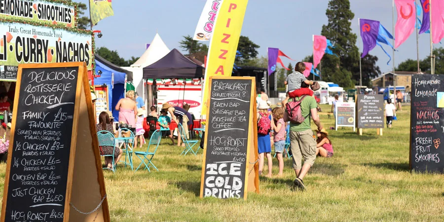 Tastybirds chalkboard menu at a sunny summer festival