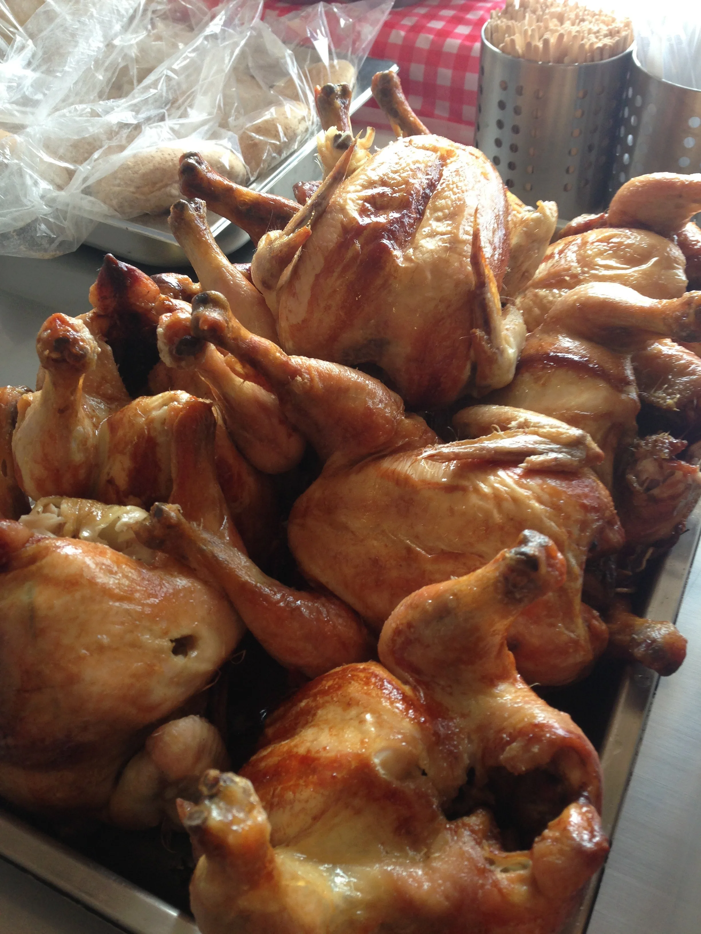 Tray of golden whole roasted chickens ready to serve