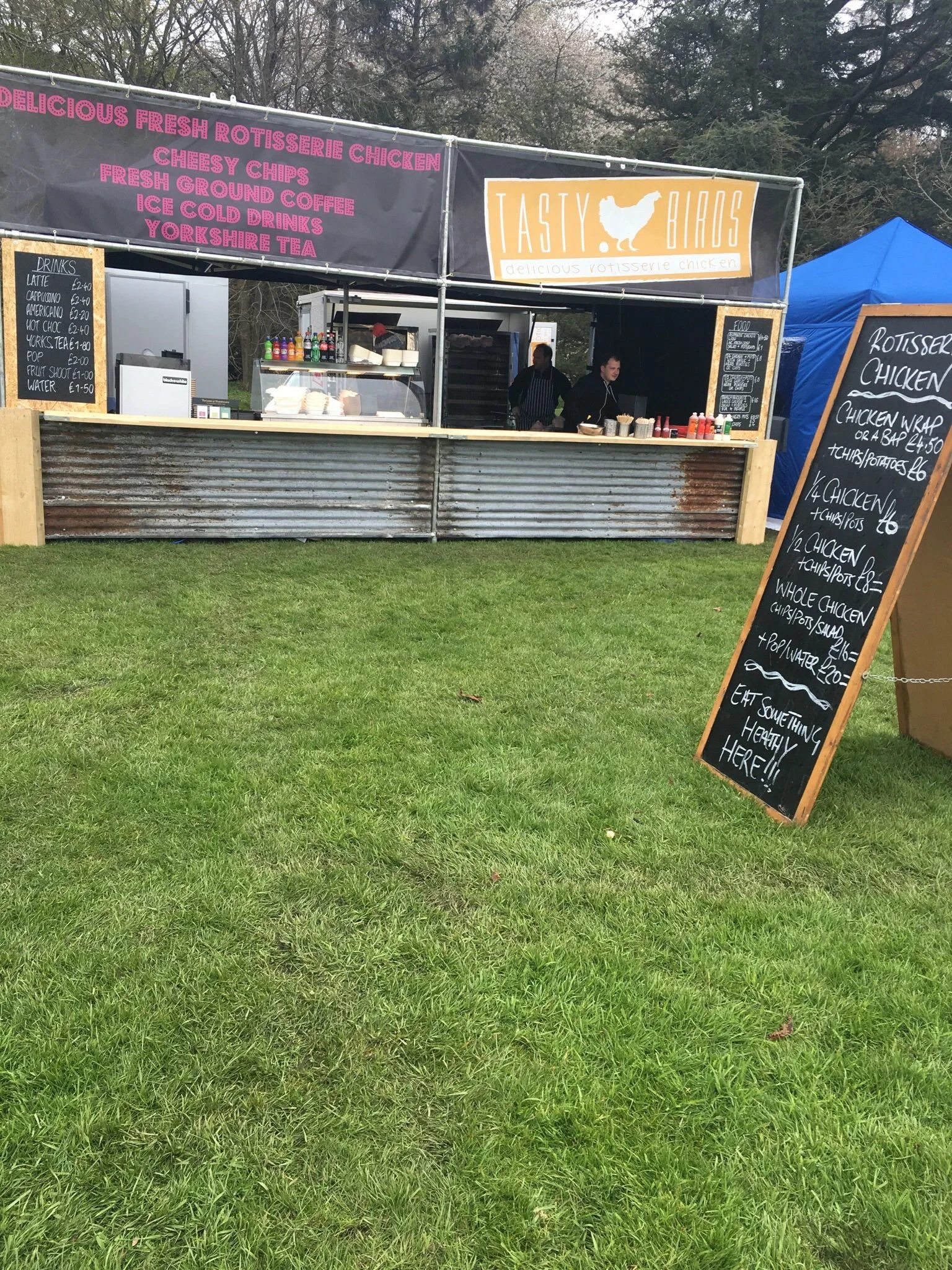 The Tastybirds stall at a festival with chalkboard menu and team